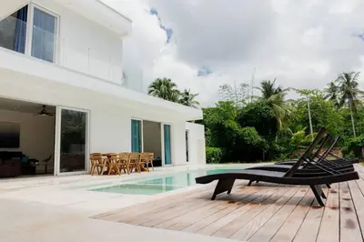 a house with a swimming pool and a wooden deck at Private Villa 4 BR at Playa Bonita, Las Terrenas in Las Terrenas