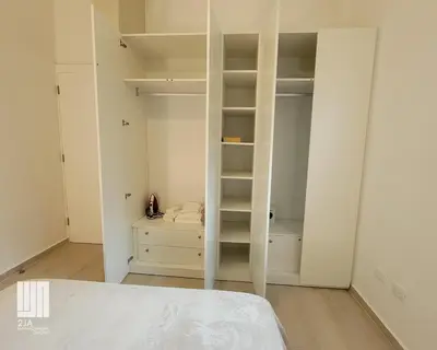 a white bedroom with a bed and a closet at 2JA Management Group - Condos White Hill in Sosúa