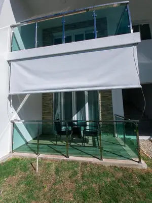 a patio with a table and chairs under awning at 2JA Management Group - Condos White Hill in Sosúa