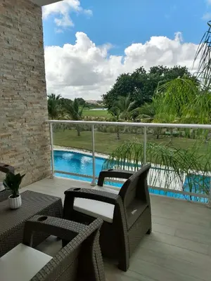 a balcony with a view of a swimming pool at Hard Rock at Cana Pearl 1 by Unwind Properties in Punta Cana