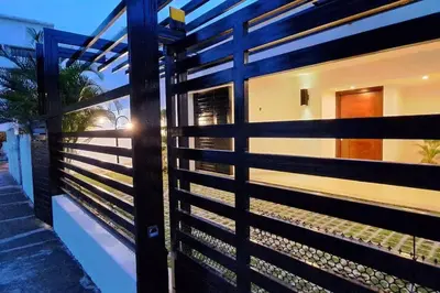 a wooden fence in front of a house at Deluxe villa with jacuzzi and beautiful garden in Santiago de los Caballeros