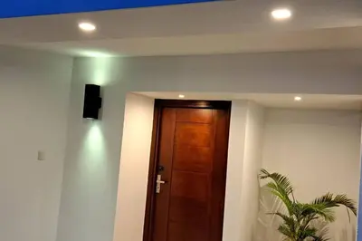 a hallway with a wooden door and a speaker on a wall at Deluxe villa with jacuzzi and beautiful garden in Santiago de los Caballeros