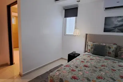 a bedroom with a bed and a window at Deluxe villa with jacuzzi and beautiful garden in Santiago de los Caballeros