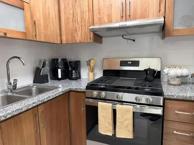 a kitchen with a stove and a sink at Rustic Elegance St in Santiago de los Caballeros