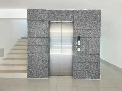 a metal elevator in a building with stairs at Rustic Elegance St in Santiago de los Caballeros