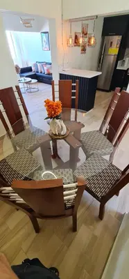 a living room with a table and chairs at Apartament central frente al mar in San Felipe de Puerto Plata