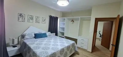 a bedroom with a bed with a blue pillow on it at Apartament central frente al mar in San Felipe de Puerto Plata