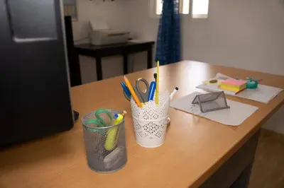 a desk with two cups filled with pens and scissors at Villa Caribe in Bayahibe