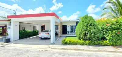 a white car parked in front of a house at Pine Tree Entire House 2B Gated Com in Higuey