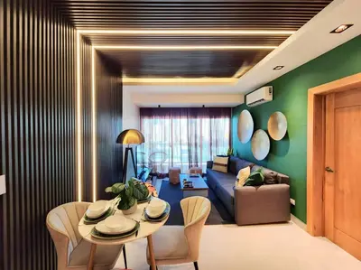a living room with a table and a couch at Stunning infinity pool apartment in Santo Domingo