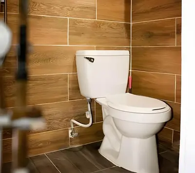 a white toilet in a bathroom with wooden walls at Apart hotel Costa Verde,#1 Exclusivo y seguro con cama Queen in Las Galeras