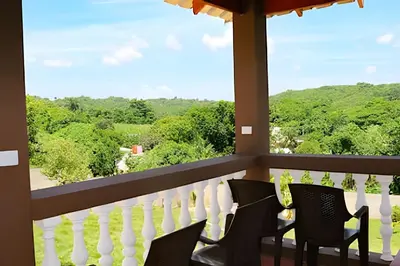 a balcony with chairs and a view of the mountains at Apart hotel Costa Verde,#1 Exclusivo y seguro con cama Queen in Las Galeras