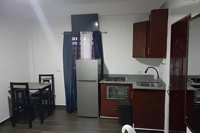 a kitchen with a refrigerator and a table in it at Apart hotel Costa Verde,#1 Exclusivo y seguro con cama Queen in Las Galeras