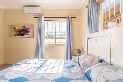a bedroom with a bed and a window at Sky Blue in Jarabacoa