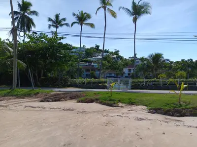 a view of a beach with palm trees and a house at Bonita Village Beachfront Apt with Pool & Balcony in Las Terrenas