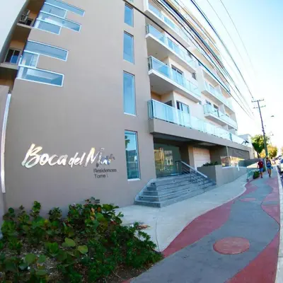 a building with a sign on the side of it at Confortable apto. en Boca Chica in Boca Chica