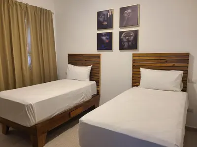two beds sitting next to each other in a room at Hard Rock Punta Cana Luxe Apartment 2BR Coral Bay by BTC Crypto Group in Punta Cana