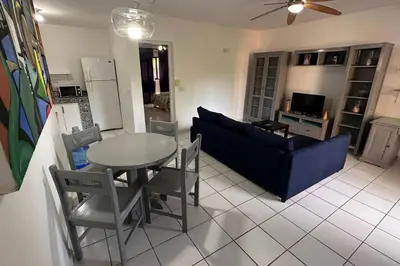 a living room with a blue couch and a table at Caribe Campo Sosua in Sosúa