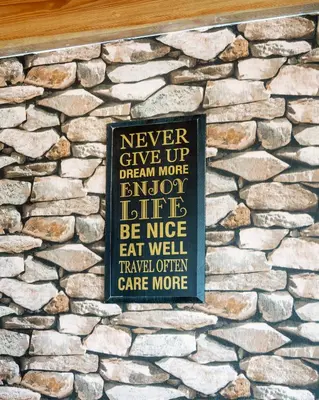 a sign on the side of a stone wall at Paradise Dream Dominicus in La Laguna