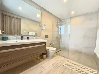 a bathroom with a sink and a toilet and a shower at 2BR Beach Condo • Prime Location Across Hard Rock in Punta Cana