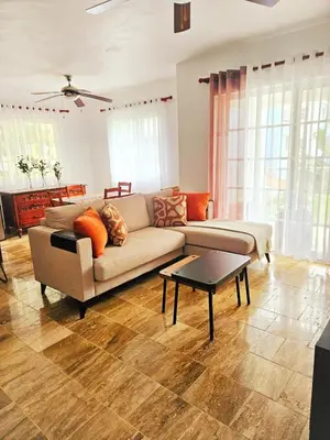 a living room with a couch and a table at Madonna1 pool beach los corales Arenas de Bavaro in Punta Cana