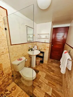 a bathroom with a toilet and a sink at Madonna1 pool beach los corales Arenas de Bavaro in Punta Cana