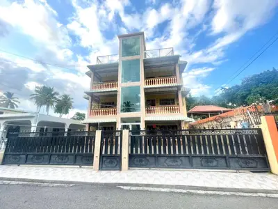 a tall building with a fence in front of it at Oasis de Paz 4 in Jarabacoa