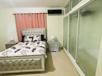 a small bedroom with a bed and a shower at Oasis de Paz 4 in Jarabacoa
