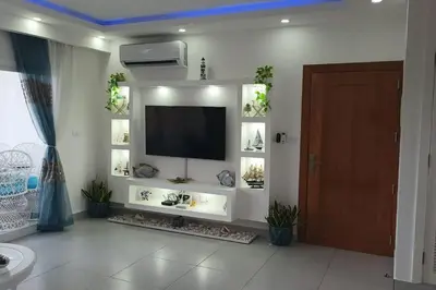 a living room with a flat screen tv on a wall at Confortable apartamento en Playa Nueva Romana in San Pedro de Macorís