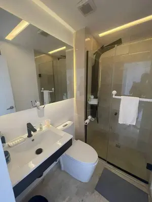 a bathroom with a toilet and a sink and a shower at Hard Rock at Cana Rock 3 by Unwind Properties in Punta Cana