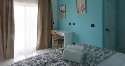 a bedroom with a bed and a desk and a chair at All Seasons Hotel in Bayahibe