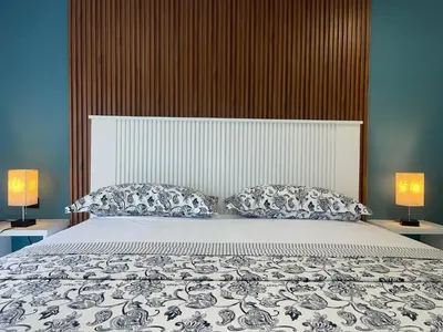 a bedroom with a large bed with two lamps at All Seasons Hotel in Bayahibe