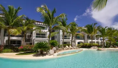a resort with a swimming pool and palm trees at Star of Caribbean- Estrella Dominicus Bayahibe in Bayahibe