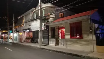 an empty street at night with a building at Classic House, Modern Spaces in Baní