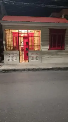 a house with red and yellow windows on a street at Classic House, Modern Spaces in Baní