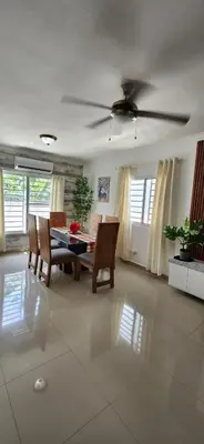 a living room with a table and a ceiling fan at Rooftop with Pool, La Romana, Villa Doña Julia, At Paula Isabel in La Romana