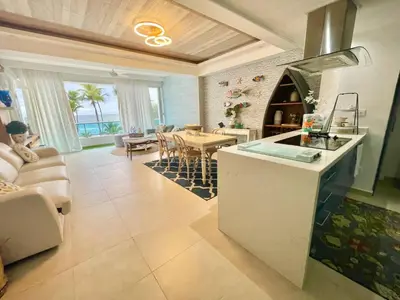 a kitchen and living room with a table and a dining room at Enjoy beach life at this gated in Juan Pedro