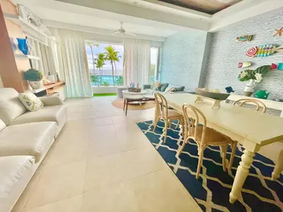 a living room with a table and a couch at Enjoy beach life at this gated in Juan Pedro