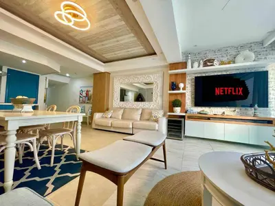 a living room with a tv and a kitchen at Enjoy beach life at this gated in Juan Pedro