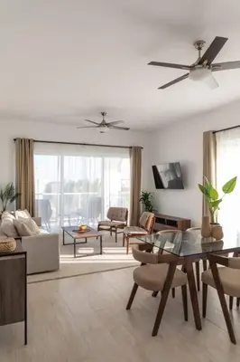 a living room with a couch and a table at Modern & relaxing penthouse Lake and Golf View in Punta Cana