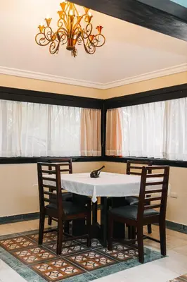 a dining room with a table and chairs and a chandelier at Hotel Plaza Brisas in Punta Cana