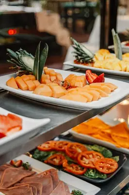 three plates of food on a buffet table at Hotel Plaza Brisas in Punta Cana