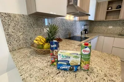 a kitchen counter with some food and a basket of fruit at Beautiful Penthouse with private elevator in Hard Rock Golf in Punta Cana