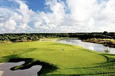 a view of a golf course with a lake at Beautiful Penthouse with private elevator in Hard Rock Golf in Punta Cana