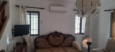 a living room with a couch and a flat screen tv at SDQ Villa Isabel, NO FUMAR, cerca embajada EEUU in Santo Domingo