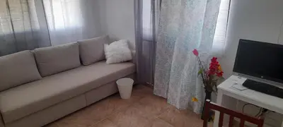 a living room with a couch and a computer on a desk at SDQ Villa Isabel, NO FUMAR, cerca embajada EEUU in Santo Domingo