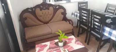 a living room with a chair and a table with a plant at SDQ Villa Isabel, NO FUMAR, cerca embajada EEUU in Santo Domingo