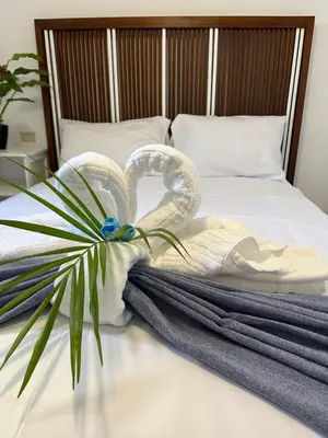 a towel and a plant on a bed at EL TOUCAN, Apartament in bayahibe in Bayahibe