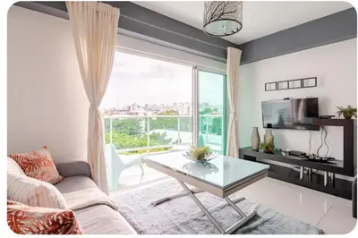 a living room with a couch and a glass table at Condo Apartment in Ciudad Nueva