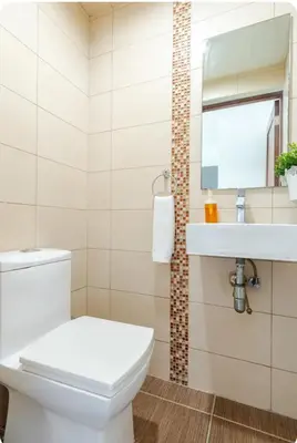 a bathroom with a white toilet and a sink at Condo Apartment in Ciudad Nueva